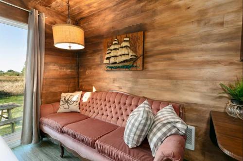 a leather couch in a room with a wooden wall at Breakwater Resort in Grayland