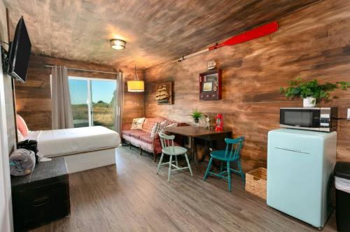 a small room with a bed and a table in it at Breakwater Resort in Grayland