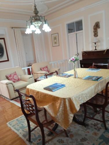 a living room with a table and a piano at St Mary House in Tomar