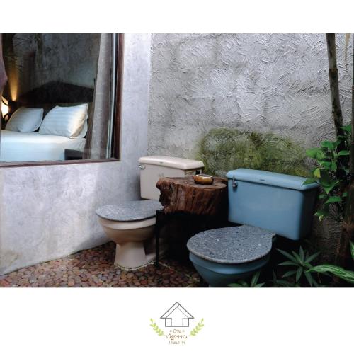 a bathroom with a toilet and a bed and a mirror at บ้านณัฐวรรณ หัวหิน Zone B - Baan Nattawan Huahin Zone B in Hua Hin