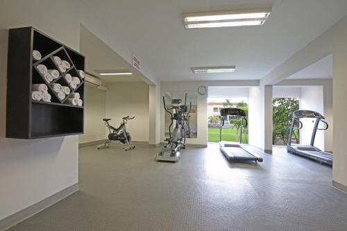 a gym with treadmills and exercise bikes in a room at voco Hermosillo by IHG in Hermosillo