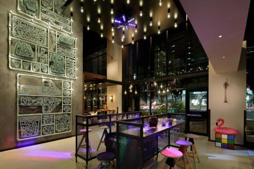 a bar with pink stools in a restaurant at Moxy Osaka Umeda in Osaka