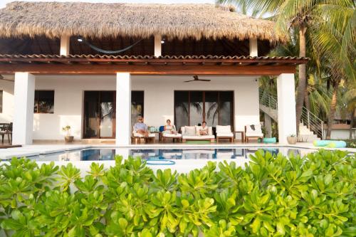 a villa with a swimming pool and a resort at Casa Brisas in Troncones