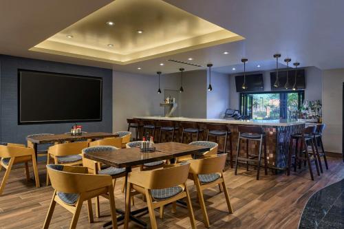 a restaurant with tables and chairs and a bar at Residence Inn by Marriott Scottsdale Salt River in Scottsdale