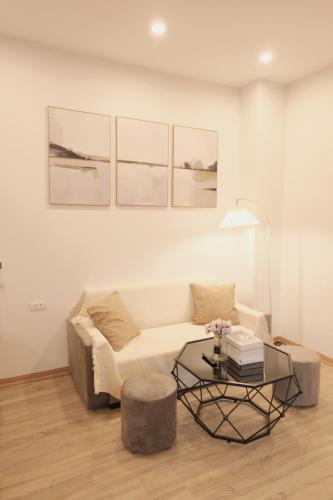 a living room with a couch and a coffee table at Sam Sam Studio - 2 Dragons WestLake - Washing machine in Hanoi