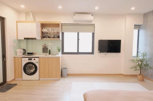 a kitchen with a washing machine in a room at Sam Sam Studio - 2 Dragons WestLake - Washing machine in Hanoi