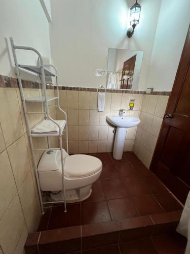 a bathroom with a toilet and a sink at NEIZAN HOTEL in Antigua Guatemala