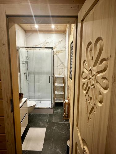 a bathroom with a shower and a toilet and a sink at Chochołowski Zakątek in Chochołów