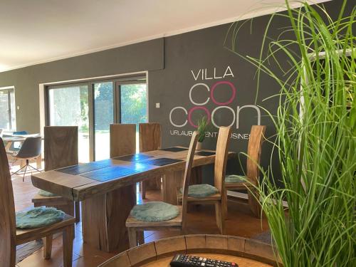 a dining room with a wooden table and chairs at Villa Münchweiler in Münchweiler Rodalb