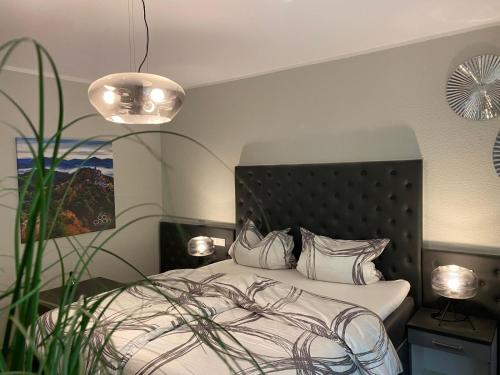 a bedroom with a bed with white sheets and pillows at Villa Münchweiler in Münchweiler Rodalb