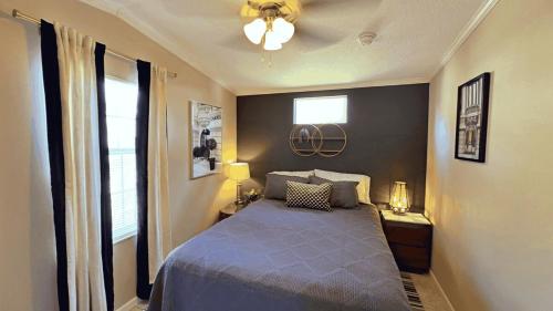 a bedroom with a blue bed and a window at Serenity Cabin in Dover