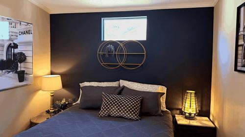 a bedroom with a bed with a black wall at Serenity Cabin in Dover