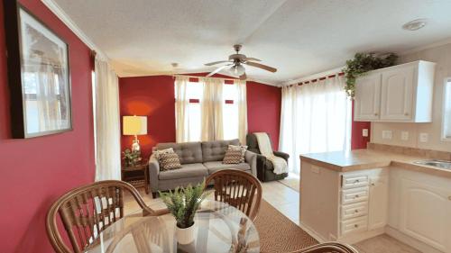 a kitchen and living room with a couch and a table at Serenity Cabin in Dover