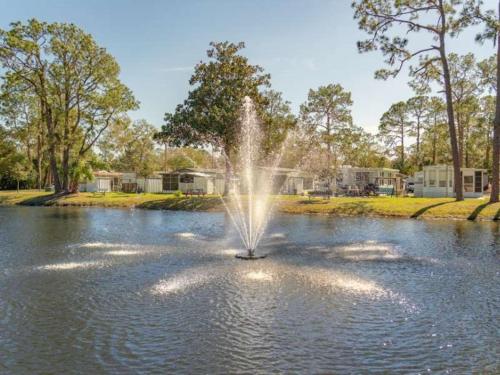 a fountain in the middle of a pond at Serenity Cabin in Dover
