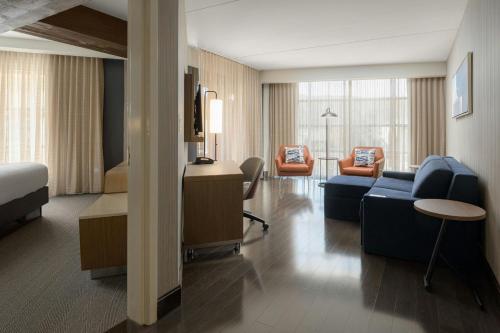 a hotel room with a bed and a living room at Courtyard by Marriott Gatlinburg Downtown in Gatlinburg