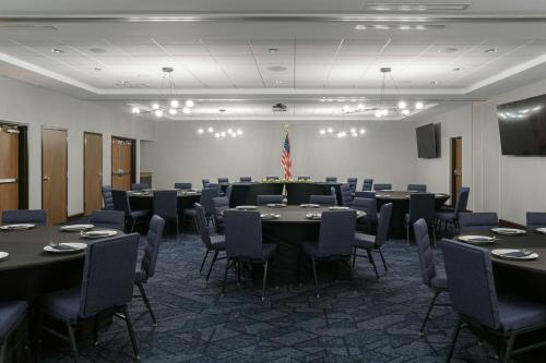 a conference room with tables and chairs and a flag at Courtyard by Marriott Gatlinburg Downtown in Gatlinburg
