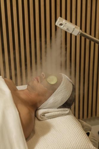 a man laying in a hospital bed with a bandaged head at Medano Hotel and Spa in Cabo San Lucas