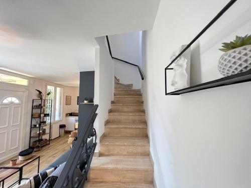 un escalier dans une maison aux murs blancs et au parquet dans l'établissement Charming seaside house 2 bedrooms, à Marseille