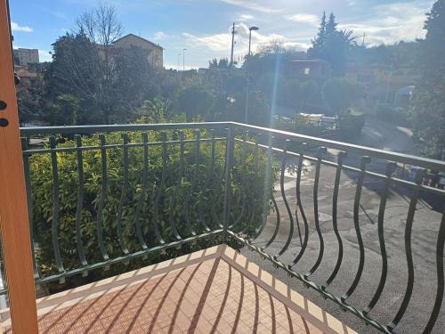 a balcony with a metal railing and a street at Brezza Marina in Pietra Ligure