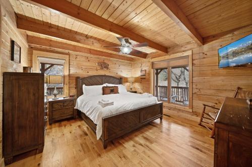 a bedroom with a bed and a ceiling fan at Freedom Lodge in Blowing Rock