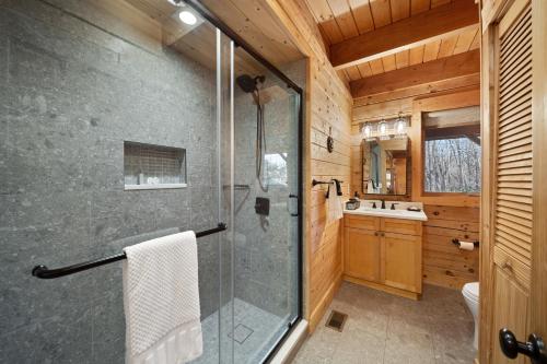 a bathroom with a glass shower and a sink at Freedom Lodge in Blowing Rock