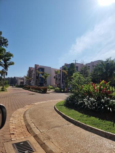 a winding street with plants and buildings in the background at BLT at Pearl Marina Estate Garuga in Entebbe
