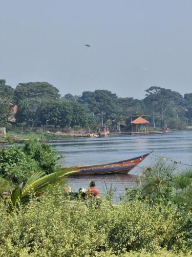 a group of people in a boat on a river at BLT at Pearl Marina Estate Garuga in Entebbe