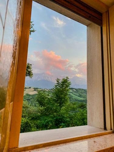 a window with a view of a mountain at Casa Vacanze Maja e Ermes in Arsita