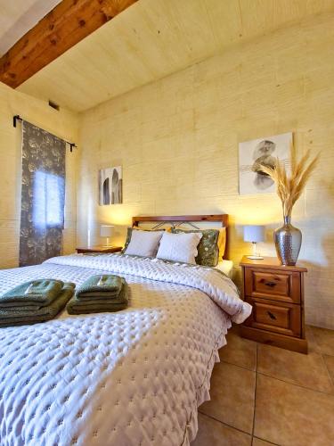 a bedroom with a large bed in a room at Moonshine Villa in Nadur