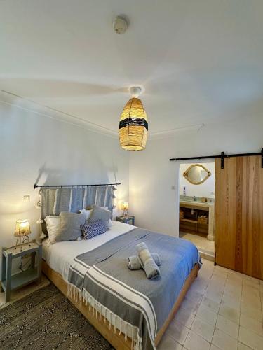 a bedroom with a large bed with a blue blanket at Villa Nour in Essaouira
