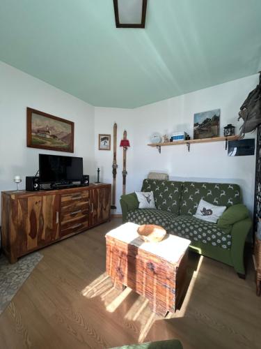 a living room with a couch and a coffee table at Casa Lucrezia - Valbruna in Valbruna