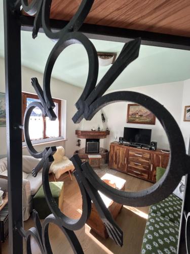 a view of a living room with a sculpture of the letter k at Casa Lucrezia - Valbruna in Valbruna