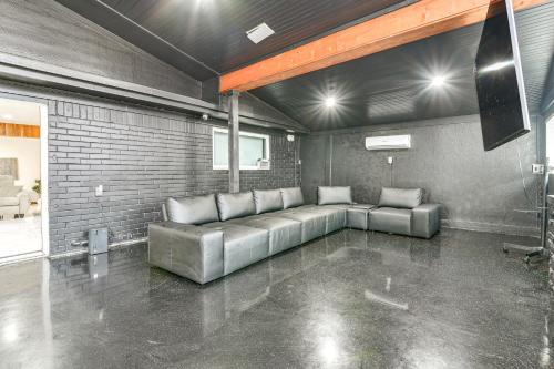 a living room with a couch in the middle of a room at Modern Oasis with Outdoor Lounge in Houston! in Houston