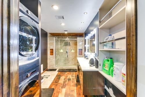 a bathroom with a shower and a washer and dryer at Modern Oasis with Outdoor Lounge in Houston! in Houston