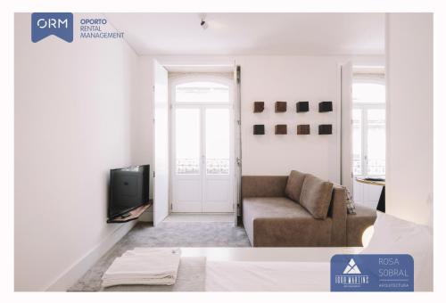 a living room with a couch and a television at ORM - Almada Apartments in Porto