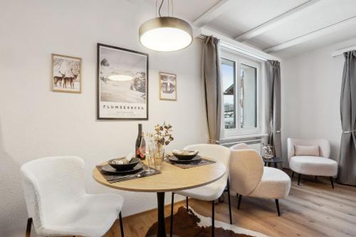 a dining room with a table and chairs at INN JOY Apartments - Cozy Ski Oase in Flums
