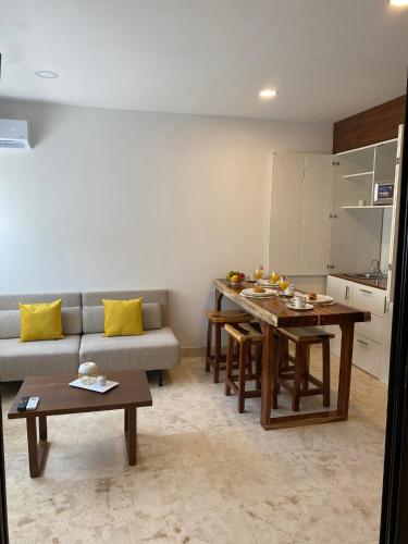a living room with a couch and a table at Anah Village in Akumal