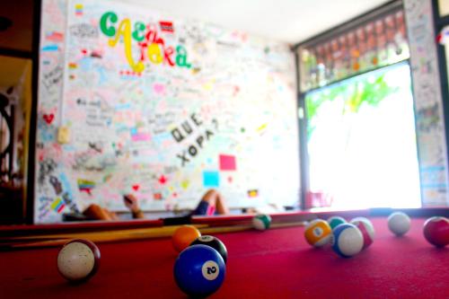 a person is playing a game of billiard at Casa Areka in Panama City