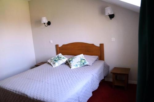 une chambre avec un lit avec deux oreillers dessus dans l'établissement La résidence du Lac - maeva Home - Appartement 2 pièces 5 personnes - Sélection MAE-4254, à Monflanquin