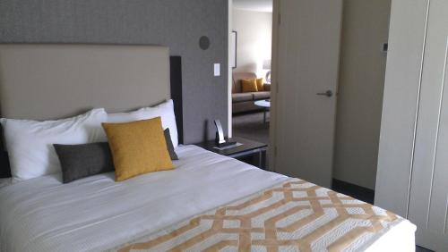a bedroom with a large white bed with pillows at Coast Kamloops Hotel & Conference Centre in Kamloops