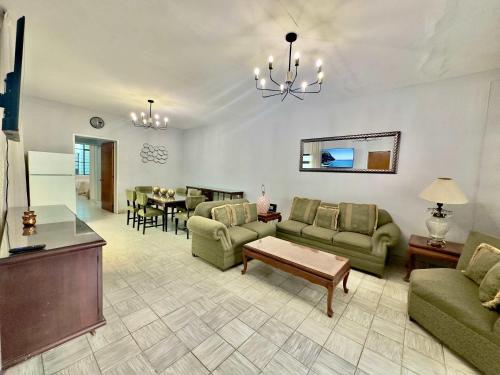 a living room with couches and a dining room at Villa by Centro Medico Occidente 3 br in Guadalajara