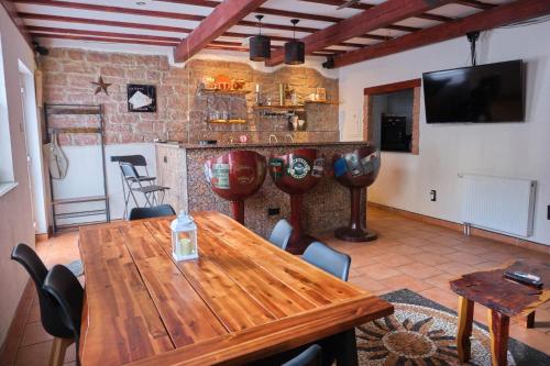 a dining room with a wooden table and a kitchen at C&A Apartments in Kaiserslautern