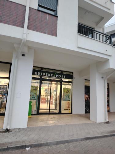 an empty store front of a white building at Apartman Bonbon in Vrnjačka Banja