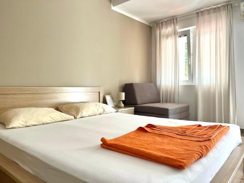 a bedroom with a bed with a brown blanket on it at Villa Mila in Petrovac na Moru