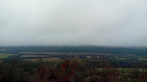 a view of a foggy field with trees and houses at Salasuka Views in Dryanovo