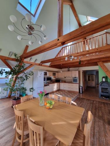 a kitchen and dining room with a table and chairs at Penzion U Lucerny in Jindrichuv Hradec