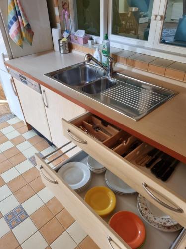 a kitchen with a sink and some plates and a counter at Penzion U Lucerny in Jindrichuv Hradec