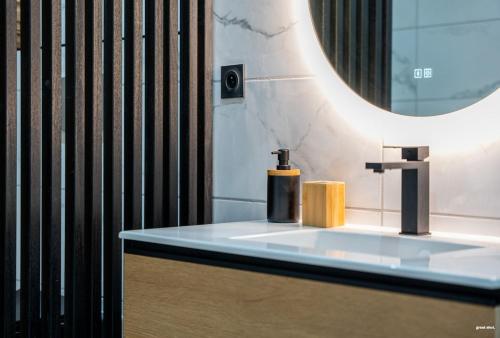 une salle de bain avec un lavabo et un miroir dans l'établissement La tavernne de Balaach Clim Wifi Cozy, à Carcassonne