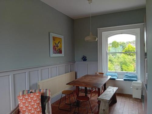 a dining room with a table and a window at Upper East Wing Apartment in Richmond House in Fermoy