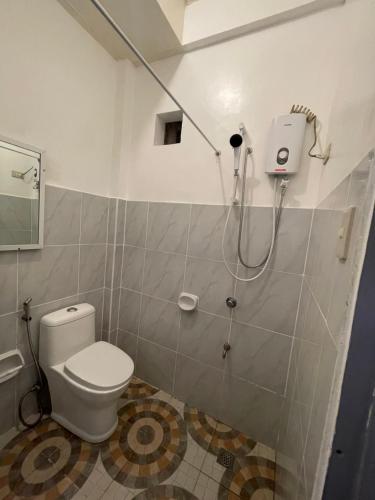 a bathroom with a toilet and a shower at Leonards Homestay in Coron